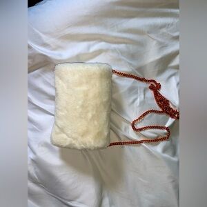 White faux fur clutch with removable rose gold chain.